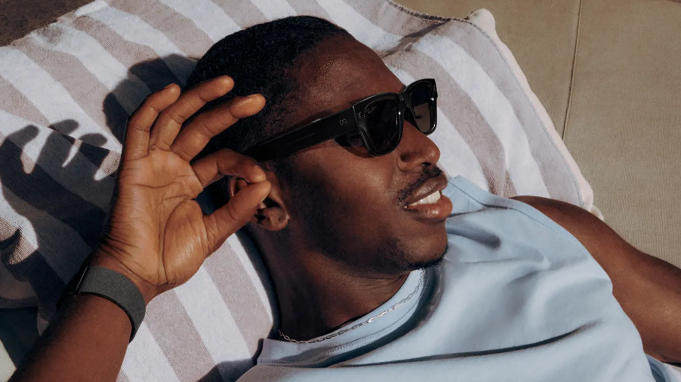 A man controls Ray-Ban Meta Display glasses with gesture